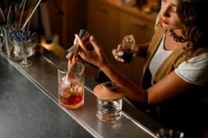 Cocktails being made at a bar.